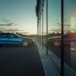 blue sedan on road during daytime