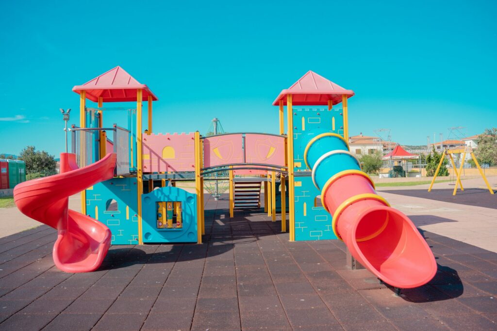 A playground with a slide and a play structure